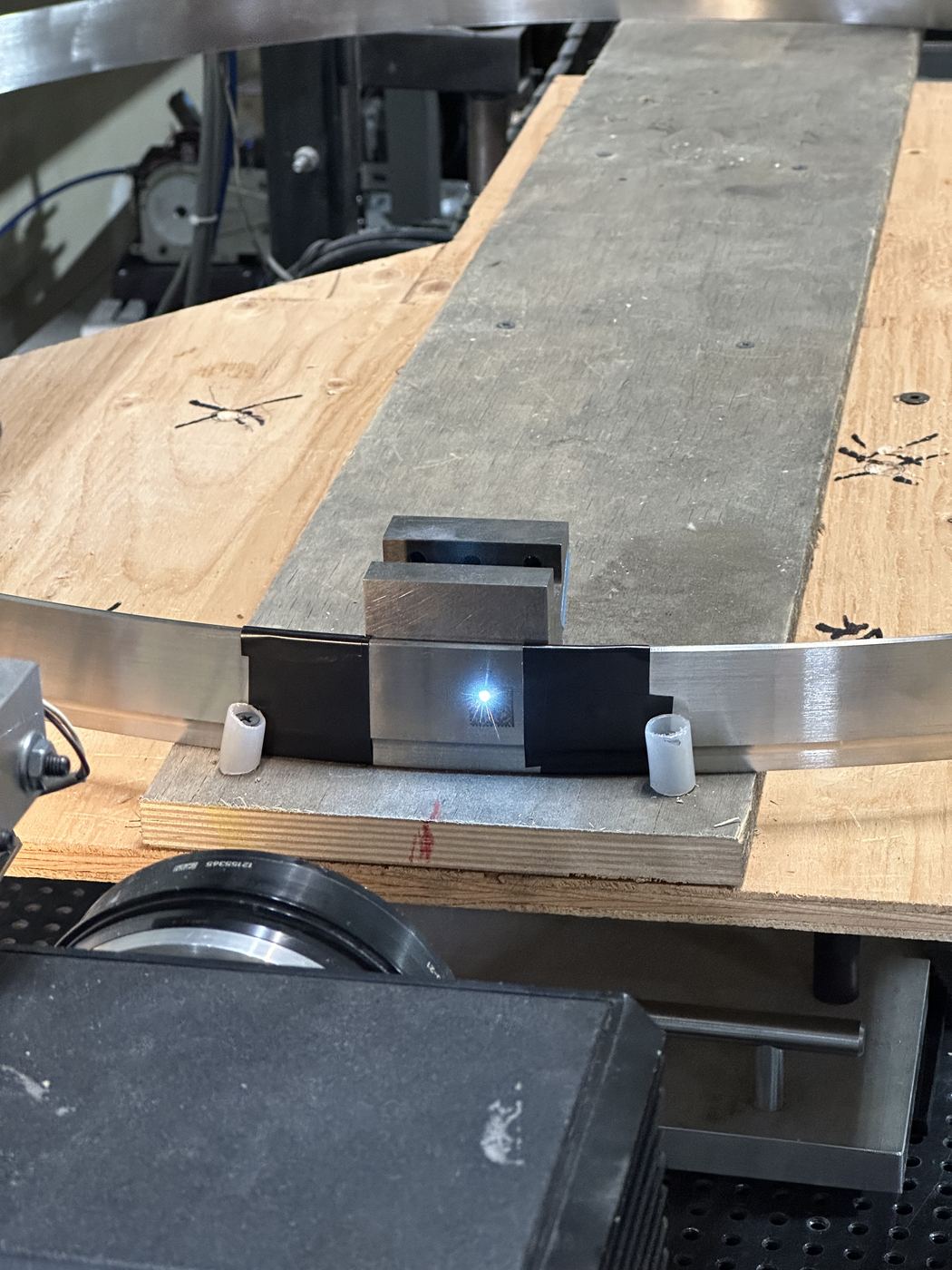 A laser marking a large steel ring in the Applied Light shop, the marking head turned 90 degrees